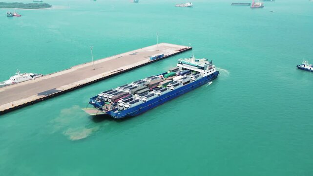 Car carrier ship. Car ferry leaving docks fully loaded.