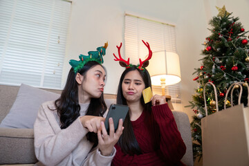 Interracial Lesbian Couple Making Online Holiday Shopping Decisions at Home