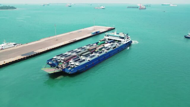 Car carrier ship. Car ferry leaving docks fully loaded.
