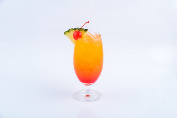 Tequila sunrise glass garnished with cherry and pine apple on the white background.