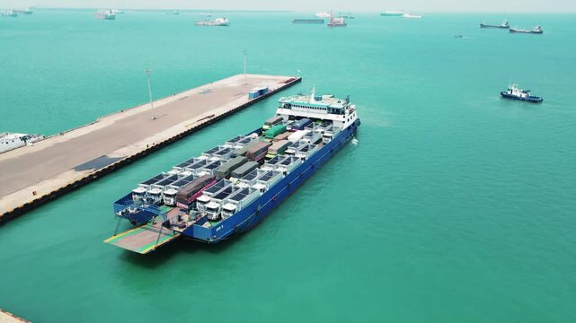 Car carrier ship. Car ferry leaving docks fully loaded.