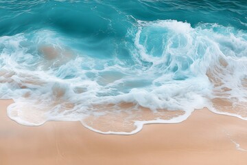 Obraz premium Serene Beach Scene: Close-Up View of Blue Waters, Beige Sand, and Waves with Beautiful Foam Textures - Peaceful Atmosphere