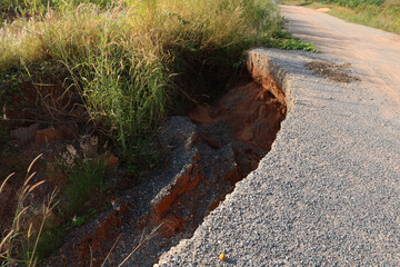 Landslide caused by rains occurs broken road asphalt. Broken asphalt road collapsed and fallen. Road collapses. Cracked asphalt road. Construction site.