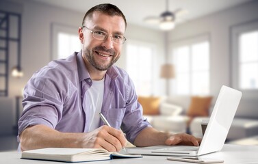 Smiling happy professional man looking at computer