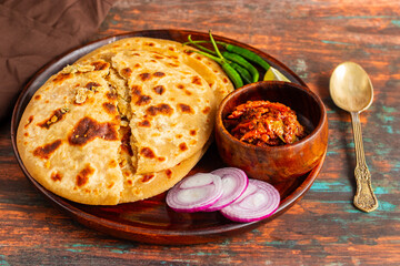 Sattu paratha is a flavorful flatbread from Uttar Pradesh and Bihar, filled with roasted gram flour, served with pickle and raita.