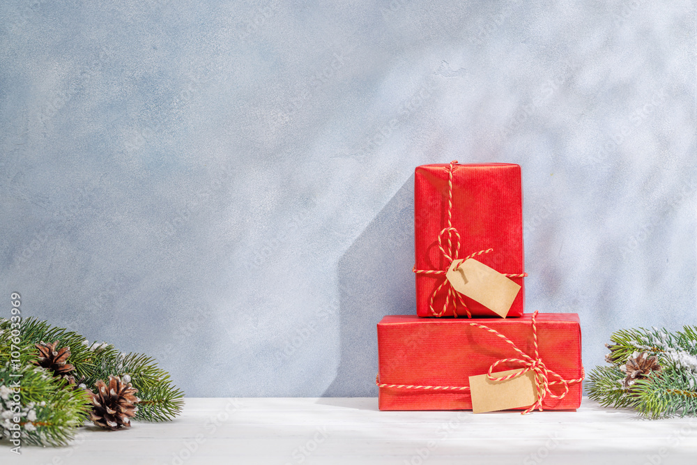 Aufkleber christmas template featuring gift boxes and snowy fir tree branches on a table with shadows and sun 