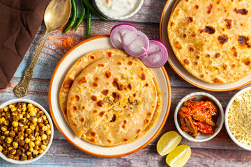 Sattu paratha, a nutritious flatbread from Uttar Pradesh and Bihar, stuffed with roasted gram flour, served with pickle and raita.