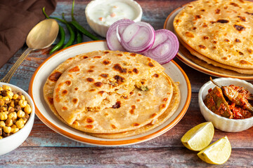Sattu paratha, a nutritious flatbread from Uttar Pradesh and Bihar, stuffed with roasted gram flour, served with pickle and raita.