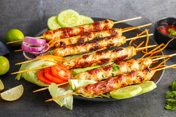 Juicy chicken seekh kababs, perfectly seasoned, served with refreshing mint chutney and tangy...
