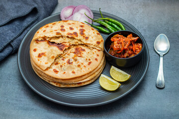 Sattu paratha, a nutritious flatbread from Uttar Pradesh and Bihar, stuffed with roasted gram flour, served with pickle and raita.