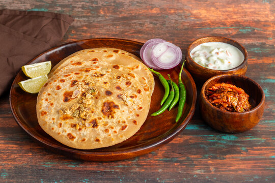 Sattu paratha is a popular stuffed flatbread from Uttar Pradesh and Bihar, served with tangy pickle and cooling raita.