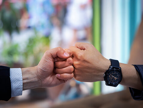 Deal of teamwork with the Man hand a fist bump commit as get together in the office