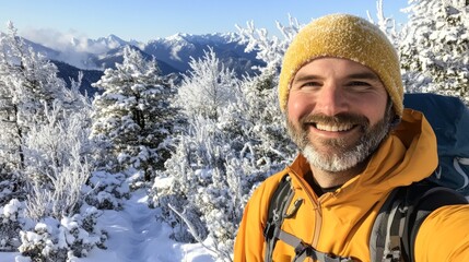Fototapeta premium Smiling Man in Yellow Jacket with Snowy Mountain Background