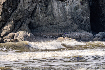 Closeup of waves crashing and sea foam on Pacific Ocean coastal shoreline Washington state
