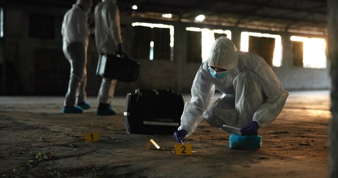 Crime, people and forensics at scene with swab, evidence and DNA sample with clue in abandoned warehouse. CSI team, hazmat suit or investigation in building for legal service, inspection or pathology