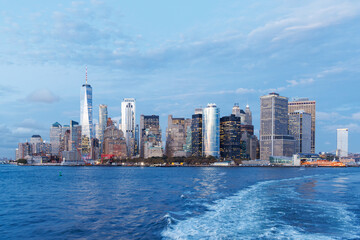 Fototapeta premium A vibrant sunset panorama of Manhattan downtown skyline, viewed from the river