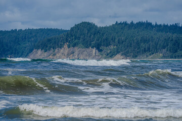 Closeup of waves crashing and sea foam on Pacific Ocean coastal shoreline Washington state