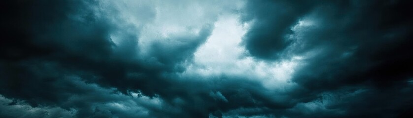 Obraz premium Dark, ominous clouds fill the sky, suggesting an impending storm or weather change.