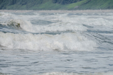 Obraz premium Closeup of waves crashing and sea foam on Pacific Ocean coastal shoreline Washington state