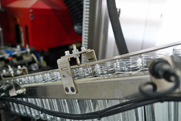 Plastic bottles on the conveyor for production in different volumes and liters.