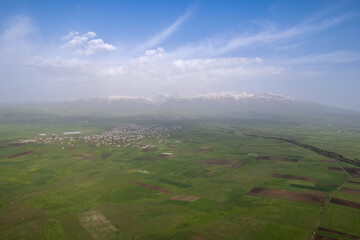 Aerial view of Mount Aragats, Shenavan, Aragats and Vardenut villages on misty spring day. Armenia.