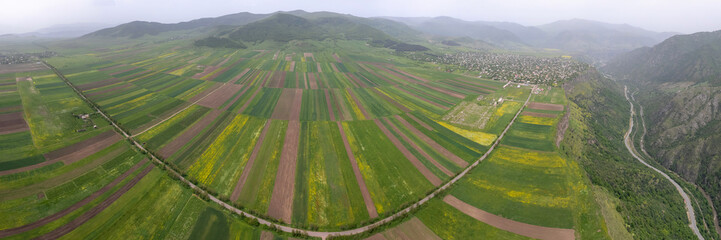 Panoramic aerial view of farmland above Debed river valley on spring day. Odzun village, Armenia.