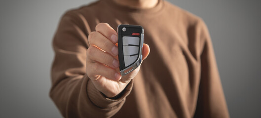 Caucasian man showing car key.