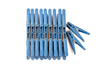 Set of clothespins isolated on a white background. Blue plastic clothespins.