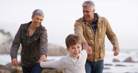 Grandparents, grandchild and walking on beach, outdoor and seashore for bonding together. Senior...