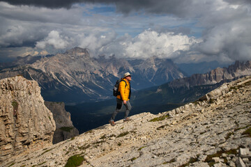 Hiker enjoys the view from Lagazuoi mountain over the italian Dolomites.