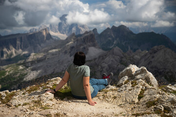 Naklejka premium Hiker woman enjoys the view from Lagazuoi mountain over the italian Dolomites.