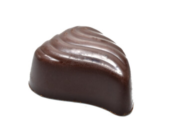 A chocolate candy in the shape of a drop of water lies on a white background.