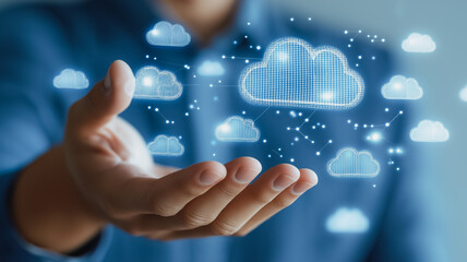 A hand is holding a cloud with a blue background. The clouds are scattered all over the image, and the hand is holding them all together. Concept of control and power