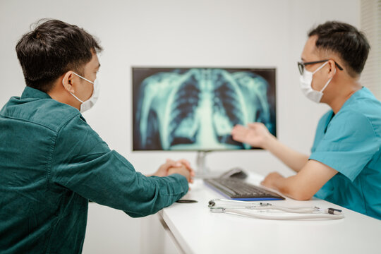 Doctor explaining lung cancer stages on a digital screen showing detailed lung diagrams, representing knowledge and guidance, modern and educational.