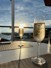 Sunset cocktail hour champagne glass on outdoor terrace deck of luxury cruiseship cruise ship liner