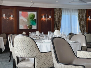 Formal and elegant ocean view dining room restaurant onboard luxury cruiseship or cruise ship liner...