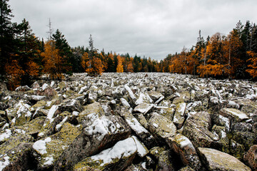 the first snow in Taganay National Park in the autumn forest on the Kamennaya river