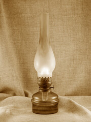 Old kerosene lamp in a glass bulb. Vintage color image.