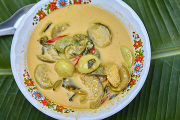Green curry chicken meat intense soup in bowl
