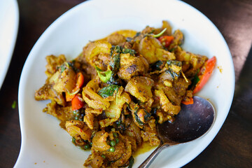 Close-up view of stir-fried spicy Boar in plate