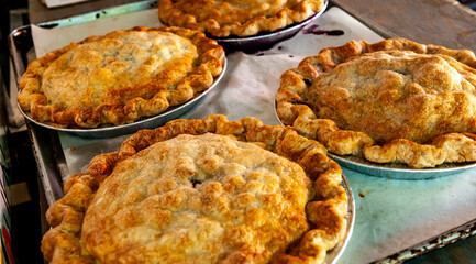 Fresh baked apple pies on a tray.