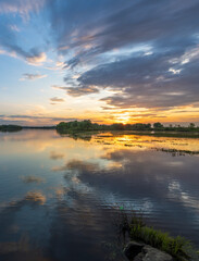 The sky is cloudy and the sun is setting