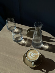 aesthetic breakfast table with coffee and still water glasses