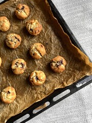 Freshly baked chocolate chip cookies on a baking sheet