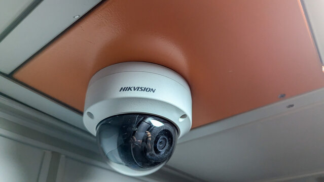 A security camera mounted on a ceiling in a modern interior, providing surveillance coverage for safety and monitoring activities in the space, Dhaka / Bangladesh - October-25-2024
