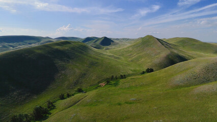 Obraz premium flying over textured green mountains in the Orenburg region