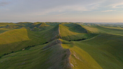 flying over textured green mountains in the Orenburg region