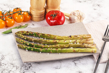 Grilled asparagus sprouts served red pepper