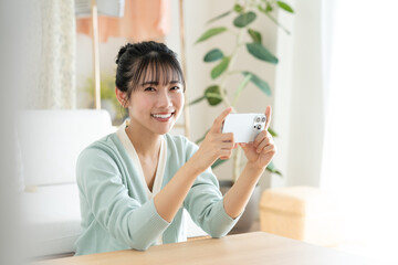 スマホで動画を見る若い女性