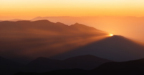 Obraz premium Foggy golden summer sunset in the mountains panoramic view nature beauty landscape background 